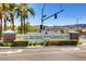 Sun City MacDonald Ranch Community Center entrance sign surrounded by lush landscaping and palm trees at 2105 Poppywood Ave, Henderson, NV 89012
