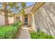 Welcoming front entrance featuring a covered porch, well-kept landscaping, and a sidelight window at 2105 Poppywood Ave, Henderson, NV 89012