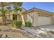 Charming single-story home with a well-manicured front yard and attached two-car garage at 2105 Poppywood Ave, Henderson, NV 89012