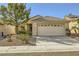 Inviting single-story home with a tile roof, two-car garage, and desert-friendly landscaping at 2105 Poppywood Ave, Henderson, NV 89012