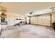 Spacious two-car garage with concrete flooring, ample shelving, and a large garage door at 2105 Poppywood Ave, Henderson, NV 89012