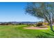 Scenic golf course view with a sand trap, manicured greens, and mountain views at 2105 Poppywood Ave, Henderson, NV 89012