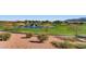 Picturesque view of a golf course featuring lush green fairways, a water hazard, and scenic landscaping at 2105 Poppywood Ave, Henderson, NV 89012