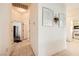 Hallway with tile flooring, neutral walls adorned with artwork, and doorways leading to various rooms at 2105 Poppywood Ave, Henderson, NV 89012