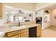 Open kitchen featuring tile floors, neutral walls, and an open view of the living room and backyard at 2105 Poppywood Ave, Henderson, NV 89012