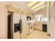 Well-lit kitchen with white appliances, light-colored cabinets, and tile flooring, ready for culinary adventures at 2105 Poppywood Ave, Henderson, NV 89012