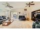 Spacious living room with carpet, ceiling fans, and a sliding glass door to the backyard at 2105 Poppywood Ave, Henderson, NV 89012
