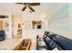 Comfortable living room with a large picture window, ceiling fan, and open layout at 2105 Poppywood Ave, Henderson, NV 89012