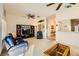 Open living room with a media center, ceiling fan, and view of the home's entrance at 2105 Poppywood Ave, Henderson, NV 89012