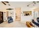 Bright and airy living room with large windows and an open floor plan to the kitchen at 2105 Poppywood Ave, Henderson, NV 89012