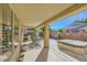 Covered patio with a built-in grill, seating area, and view of the landscaped backyard at 2105 Poppywood Ave, Henderson, NV 89012