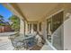 Inviting covered patio featuring a seating area and access to the home's interior through sliding glass doors at 2105 Poppywood Ave, Henderson, NV 89012