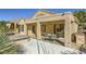 Exterior view of a covered patio, hot tub, and landscaped backyard with access to the home's interior at 2105 Poppywood Ave, Henderson, NV 89012
