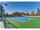 Outdoor tennis court with a green and blue surface, ideal for recreational play at 2105 Poppywood Ave, Henderson, NV 89012