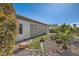 Lush backyard with desert landscaping, rocks, and artificial grass, offering a tranquil outdoor setting at 2372 Perrysburg Dr, Henderson, NV 89044