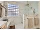 Elegant shower with marble accents, glass enclosure, and block-style window at 2372 Perrysburg Dr, Henderson, NV 89044