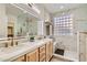 Luxurious bathroom with double sinks, marble accents, and glass-enclosed shower at 2372 Perrysburg Dr, Henderson, NV 89044