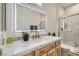 Elegant bathroom showcasing marble countertops, backlit mirror, and glass-enclosed shower with gold hardware at 2372 Perrysburg Dr, Henderson, NV 89044
