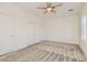 Bright bedroom with carpeted floors, ceiling fan, and a closet with sliding doors at 2372 Perrysburg Dr, Henderson, NV 89044