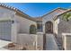 Inviting home exterior with a tiled roof, desert landscaping, and a decorative gated entryway at 2372 Perrysburg Dr, Henderson, NV 89044