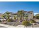 Charming single-story home with mature landscaping, desert rock and well maintained bushes and palm trees at 2372 Perrysburg Dr, Henderson, NV 89044