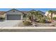 Beautiful single-story home featuring a two-car garage, desert rock yard and a well manicured lawn at 2372 Perrysburg Dr, Henderson, NV 89044