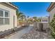 Charming walkway with brick pavers leading to a gated entrance, enhanced by desert landscaping at 2372 Perrysburg Dr, Henderson, NV 89044