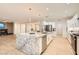 Modern kitchen boasts a granite island, stainless appliances, and open layout at 2372 Perrysburg Dr, Henderson, NV 89044
