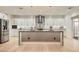 Spacious kitchen with white cabinetry, stainless steel appliances, and a large center island with granite countertop at 2372 Perrysburg Dr, Henderson, NV 89044