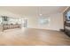 Bright and airy living room featuring a modern kitchen, wood floors, and a fireplace at 2372 Perrysburg Dr, Henderson, NV 89044