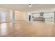 Open-concept living space connecting the kitchen, dining, and living areas with hardwood flooring at 2372 Perrysburg Dr, Henderson, NV 89044