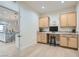 Well-lit home office with built-in desk and granite countertops, next to the kitchen at 2372 Perrysburg Dr, Henderson, NV 89044