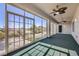 Inviting sunroom featuring large windows, ceiling fans, and an opening to the backyard at 2372 Perrysburg Dr, Henderson, NV 89044