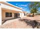 Inviting backyard featuring a covered patio, desert landscaping, and mature trees, ideal for relaxation at 2520 Springridge Dr, Las Vegas, NV 89134