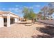 Expansive backyard with desert landscaping, mature trees, and a covered patio, perfect for outdoor living at 2520 Springridge Dr, Las Vegas, NV 89134