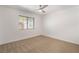 Neutral bedroom with a fan, window with blinds, and closet space offers versatility at 2520 Springridge Dr, Las Vegas, NV 89134