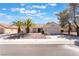 Inviting single-story home with desert landscaping, mature palm trees, and a spacious driveway leading to a garage at 2520 Springridge Dr, Las Vegas, NV 89134