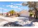 Charming single-story home with a well-manicured front yard, mature trees, and a two-car garage at 2520 Springridge Dr, Las Vegas, NV 89134