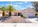 Charming single-story home with desert landscaping and beautiful palm trees in the front yard at 2520 Springridge Dr, Las Vegas, NV 89134