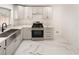 Modern kitchen with gray cabinets, marble countertops, stainless steel appliances, and a farmhouse sink at 2520 Springridge Dr, Las Vegas, NV 89134