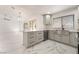 Bright, open kitchen features gray cabinets, stainless appliances, and marble countertops and floors at 2520 Springridge Dr, Las Vegas, NV 89134