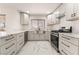 Modern kitchen with gray cabinets, marble countertops, and stainless steel appliances at 2520 Springridge Dr, Las Vegas, NV 89134