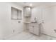 Bright laundry room with gray cabinets, white countertops, and a stainless steel sink at 2520 Springridge Dr, Las Vegas, NV 89134