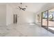 Bright living room with marble floors, a ceiling fan, and a sliding door to the backyard at 2520 Springridge Dr, Las Vegas, NV 89134
