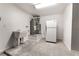 Bright utility room featuring a sink, water heater, and a full size refrigerator at 2520 Springridge Dr, Las Vegas, NV 89134