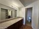 Bathroom with granite countertops, wood cabinets, a large mirror, and a toilet in a separated room at 2606 S Durango Dr # 172, Las Vegas, NV 89117