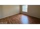 Bedroom with wood-look floors, neutral walls, and a window letting in natural light at 2606 S Durango Dr # 172, Las Vegas, NV 89117