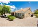 Exterior backyard view showcasing the desert landscaping, covered patio, and hot tub at 2705 Tumble Brook Dr, Las Vegas, NV 89134