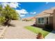 Landscaped backyard with gravel, artificial turf, flower pots, and block fence for privacy at 2705 Tumble Brook Dr, Las Vegas, NV 89134