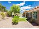 Private backyard featuring drought-tolerant landscaping, artificial grass and a cozy patio area at 2705 Tumble Brook Dr, Las Vegas, NV 89134